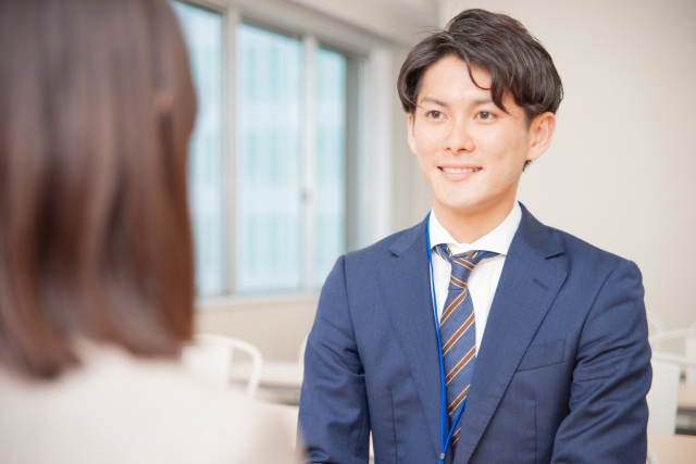 女性と話すスーツを着た男性